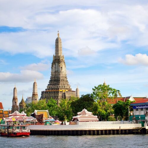 Beautiful view of Wat Arun Temple across the Chao Phraya River in Bangkok, Thailand.
