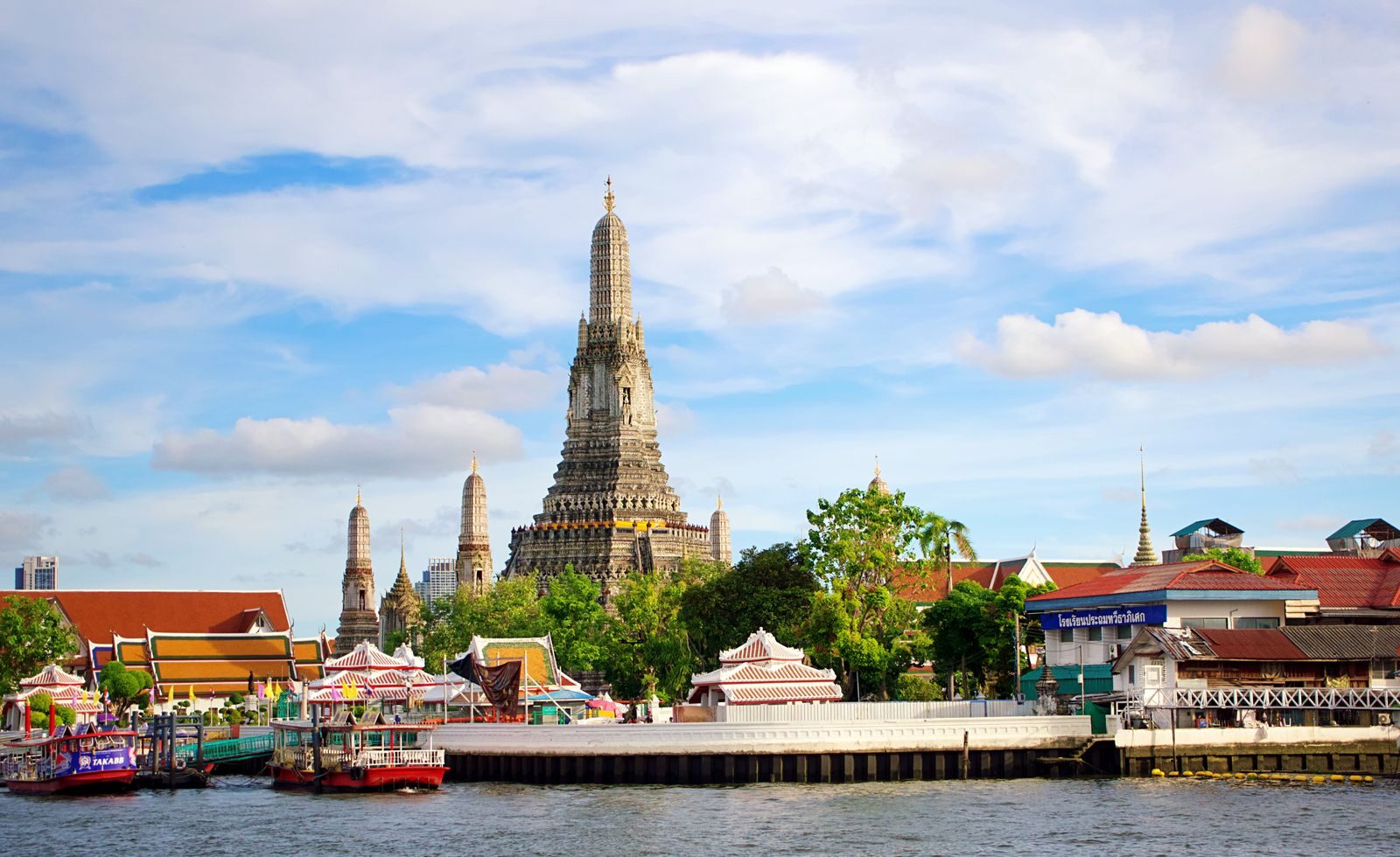 Beautiful view of Wat Arun Temple across the Chao Phraya River in Bangkok, Thailand.