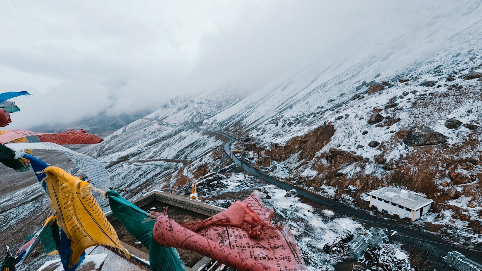person in green jacket and pink pants lying on brown wooden boat on lake during daytime