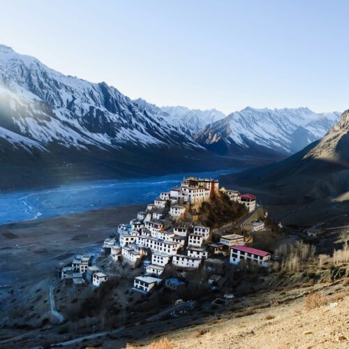 A mountain village nestled between majestic snowy peaks.